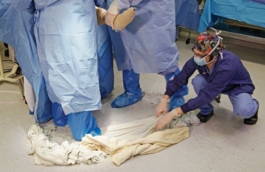 Before (left): Blankets on wet operating room floors and patient areas add to slip, trip and fall hazards. 
