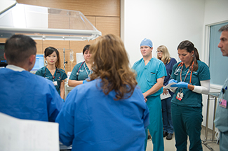 Team handoff in the simulation center after finishing the repair of the ventricular septal defect.